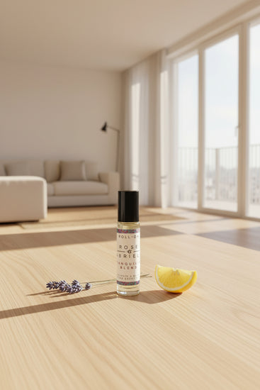 Hand holding a small bottle labeled 'Rose & Gabrielle with a roll-on design.